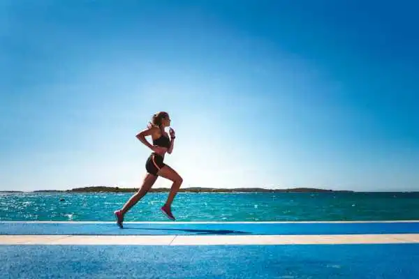 Woman running showing strong leg muscle Bournemouth